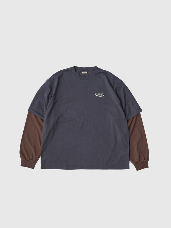【SEDAN ALL-PURPOSE|セダンオールパーパス】OVAL LOGO LAYERED TEE/オーバルロゴレイヤードL/S Tシャツ(CHARCOAL/BROWN)