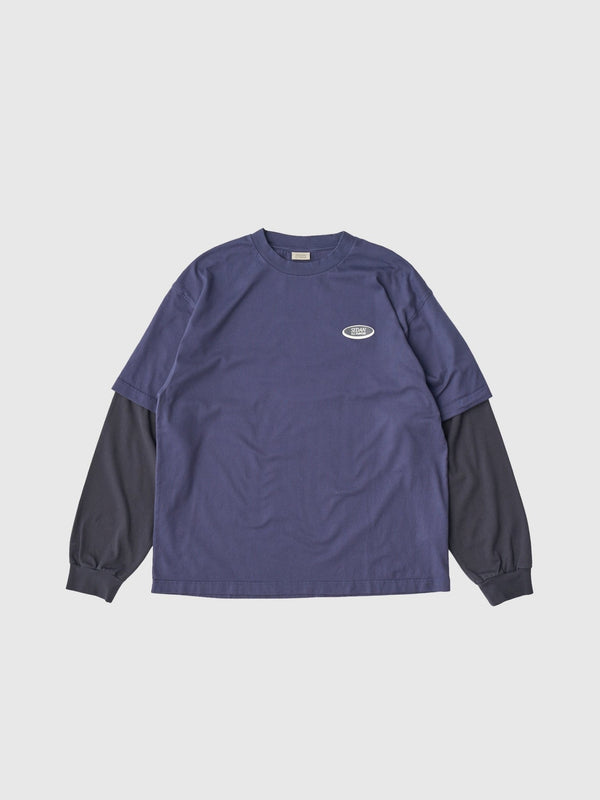 【SEDAN ALL - PURPOSE|セダンオールパーパス】OVAL LOGO LAYERED TEE/オーバルロゴレイヤードL/S Tシャツ(NAVY/CHARCOAL) - STREAM【SEDAN ALL - PURPOSE|セダンオールパーパス】OVAL LOGO LAYERED TEE/オーバルロゴレイヤードL/S Tシャツ(NAVY/CHARCOAL)STREAMM